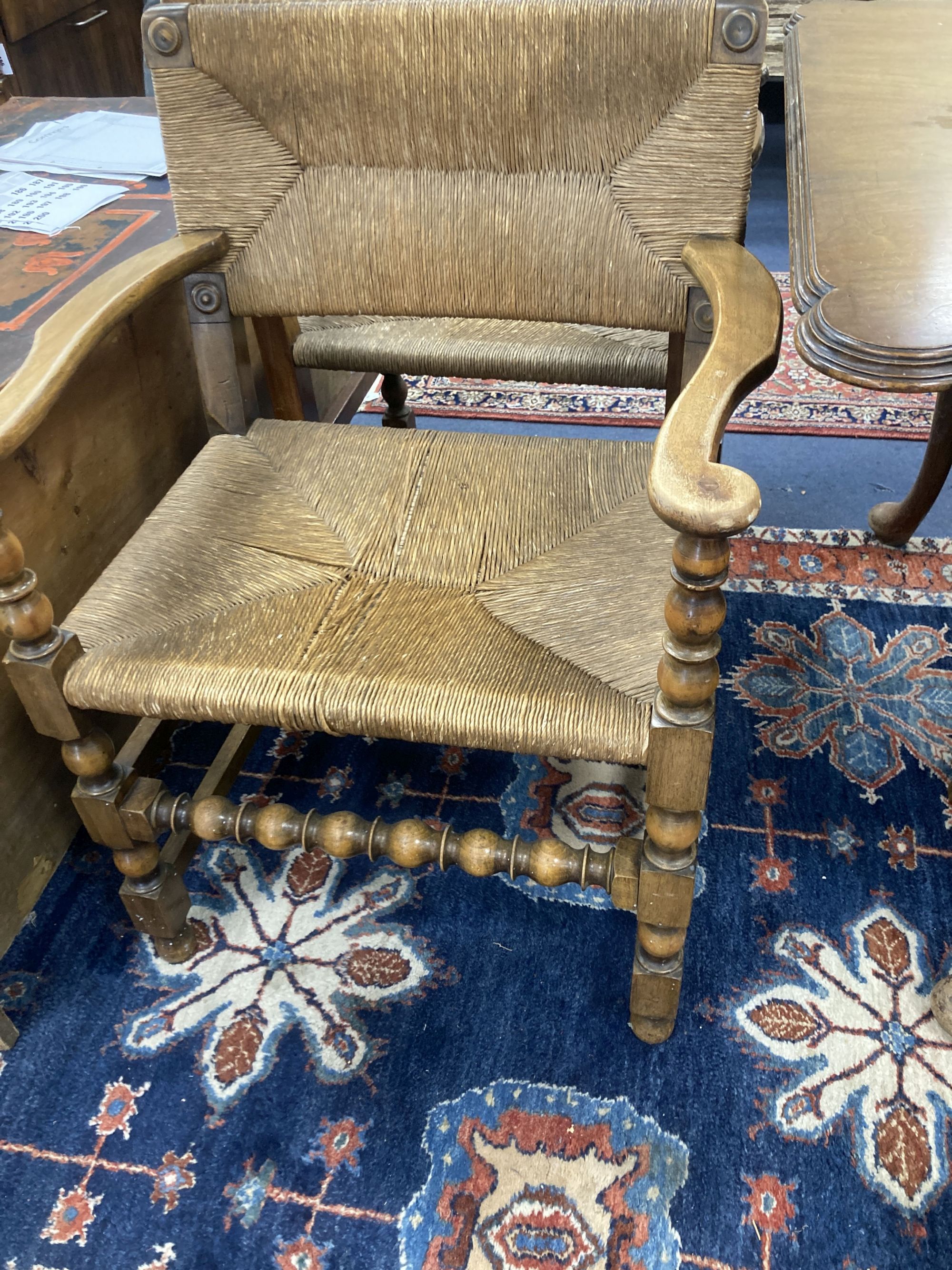 A set of eight turned beech dining chairs with rush seats and backs (two with arms)